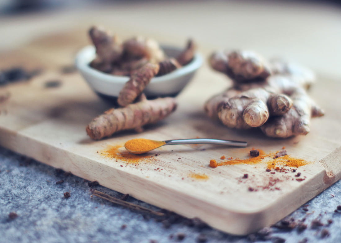 Turmeric and ginger on a wooden board