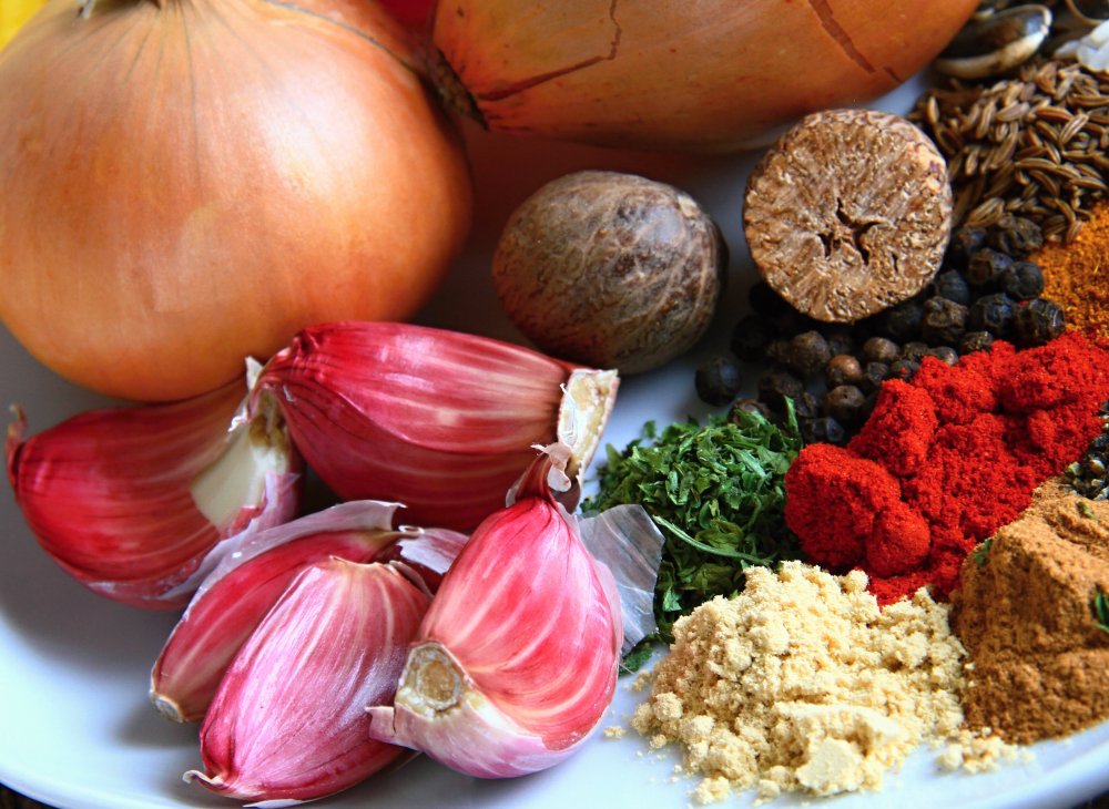 Spice powders like paprika and garlic, peppercorns, garlic cloves, cumin and onions
