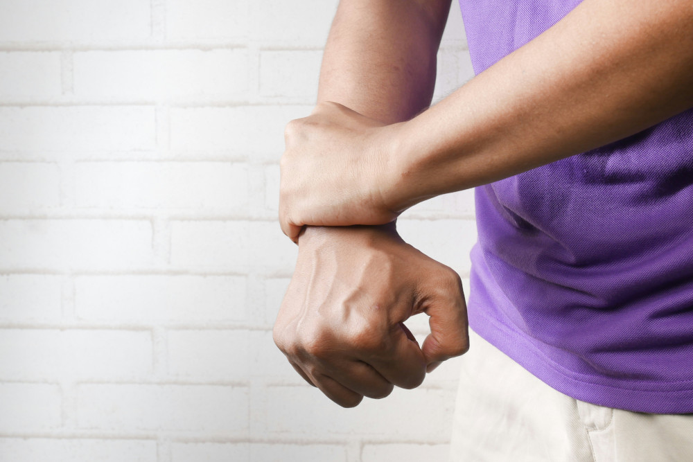 Person holding their wrist.